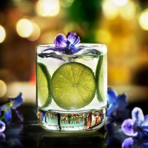 a glass of water with a purple flower on top at Hotel Ponte Sisto in Rome