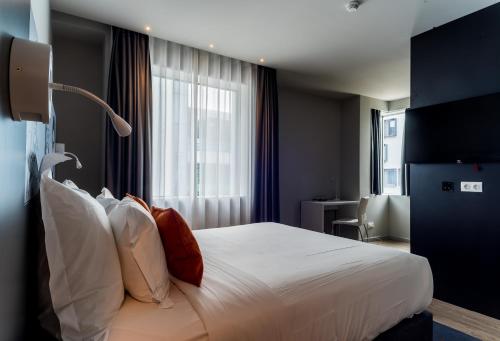 a hotel room with a bed and a window at Star inn Lisbon Airport in Lisbon