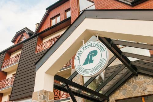 a sign on the front of a building at Centrum Promocji Leśnictwa w Mucznem in Lutowiska