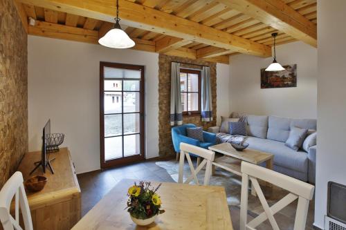 a living room with a couch and a table at Rezort Gothal Chalupy in Donovaly