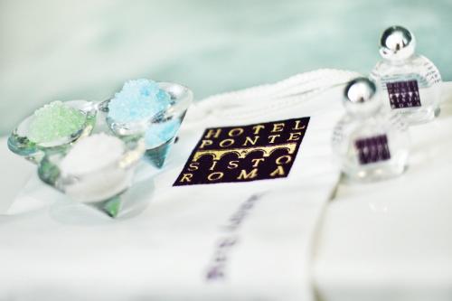a pair of engagement rings and a sign on a table at Hotel Ponte Sisto in Rome