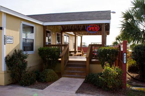 a house with a porch with a sign on it at Cotulla Homes in Cotulla