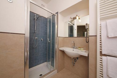 a bathroom with a sink and a shower at San Rocco Relais in Soiano del Lago