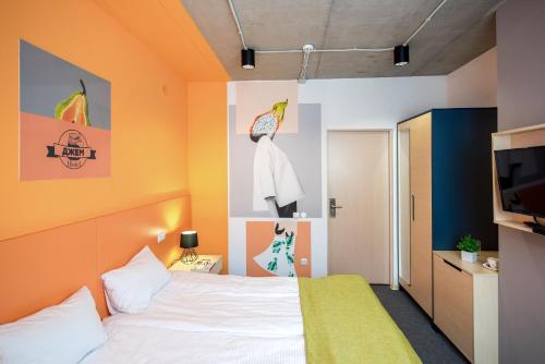a hotel room with a bed and a tv at Jam Hotel Hnatyuka in Lviv