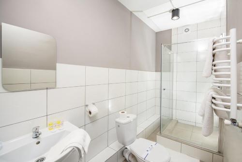 a bathroom with a toilet and a sink and a shower at Jam Hotel Hnatyuka in Lviv