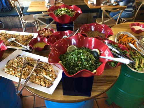 a table with a bunch of food on it at Hamra Urban Gardens in Beirut