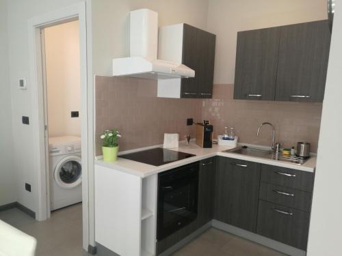 a kitchen with a sink and a washing machine at Lingotto Residence in Turin