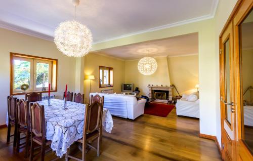 a dining room with a table and a bedroom at Casa da Oliveira in Mondim de Basto