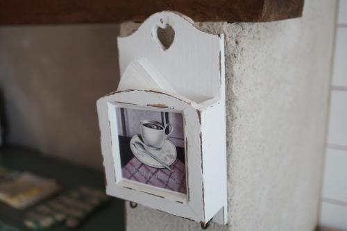 a cup and saucer in a box on a wall at Le Coin des Artistes - Cottage in Giverny