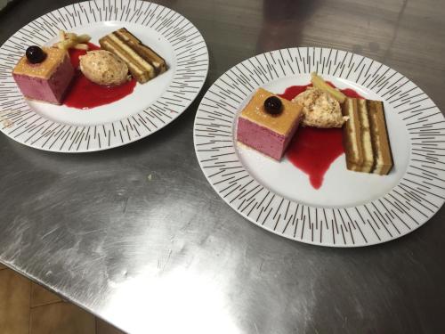 two plates of food on top of a table at Logis Hotel Le Chêne Vert in Bollène