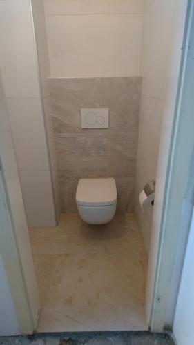 a small bathroom with a toilet and a sink at Haus Mup in Spittal an der Drau