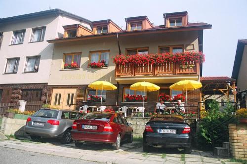 three cars parked in front of a building at Penzion Gerta in Český Krumlov