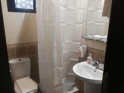 a bathroom with a toilet and a sink at Al Aseel Ajyad in Mecca