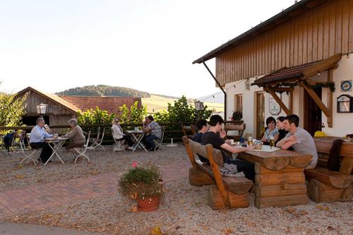 a group of people sitting at a table in a patio at Hofstub´n in Eschlkam