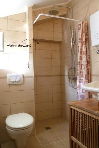 a bathroom with a toilet and a sink at Nice Apartment & Room in Cavtat in Cavtat