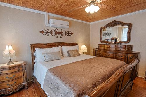 1 dormitorio con 1 cama grande y espejo en Broad River Inn, en Chimney Rock