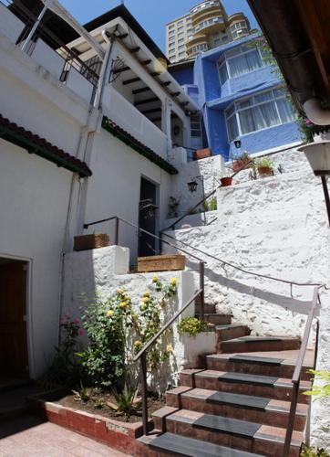 a stairway leading to a house with a blue door at Hotel Chalet Suizo in Viña del Mar