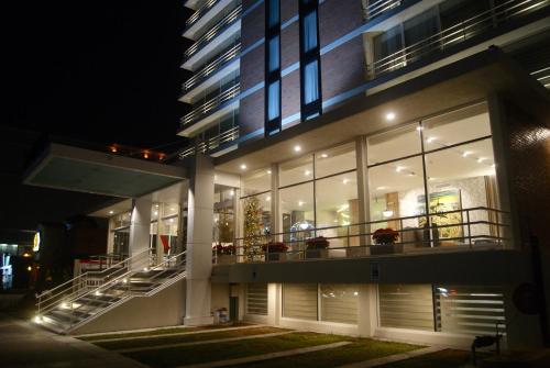 a large building with a balcony with lights at Hotel Velvet Plaza in Guadalajara