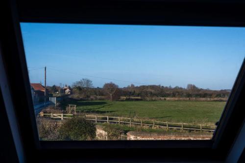 a view of a field from a window at Briarfields Hotel in Titchwell