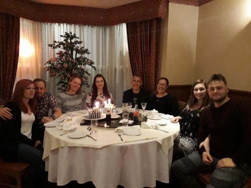 a group of people sitting around a table at Garden Hotel in Bangor