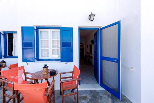 an open door to a patio with a table and chairs at Erisimo in Aegiali