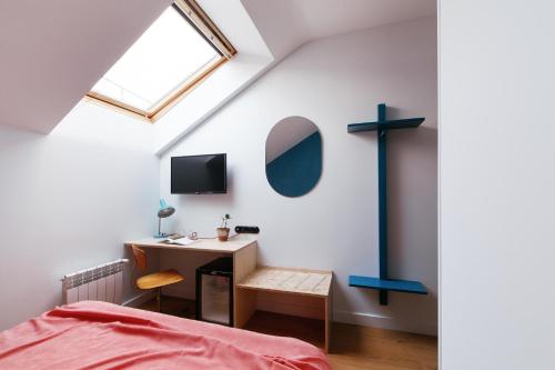 a bedroom with a desk and a cross on the wall at Pokrovka 6 Hotel in Moscow