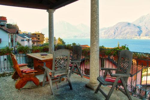 a table and chairs on a balcony overlooking the water at B&B Villa Anita in Bellano