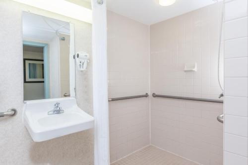 a bathroom with a sink and a shower at Wyndham Virginia Beach Oceanfront in Virginia Beach