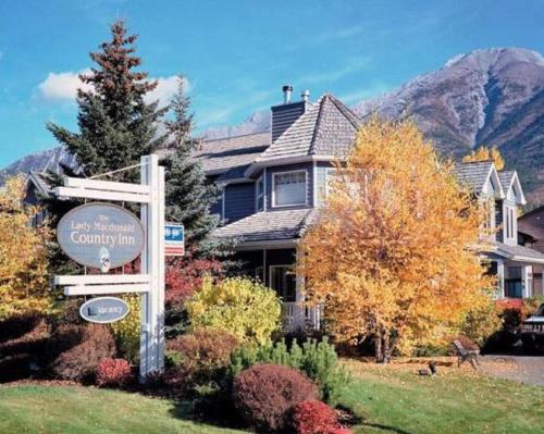 a house with a sign in front of it at Lady MacDonald Country Inn in Canmore