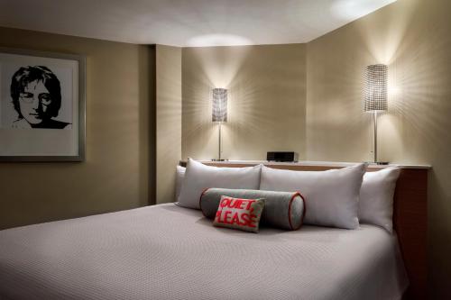 a bedroom with a king sized bed with two lights at Universal's Hard Rock Hotel® in Orlando