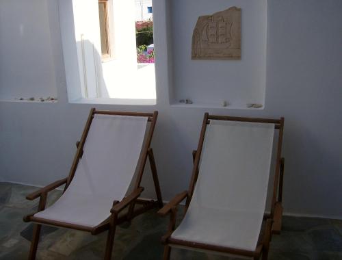 two chairs sitting in a room with a window at Hippocampus Studios in Antiparos Town