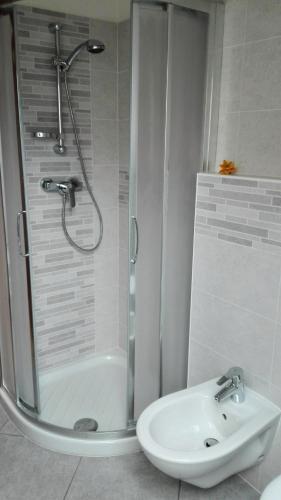 a bathroom with a shower and a sink at Boschetto in Riva del Garda