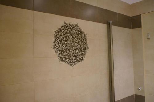 a mandala stencil on a wall in a bathroom at El Duende del Tejar in El Gastor