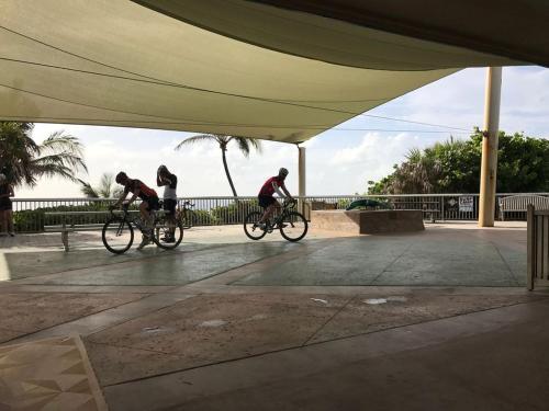 a group of three people riding bikes under a tent at Seashell 2 in Boynton Beach