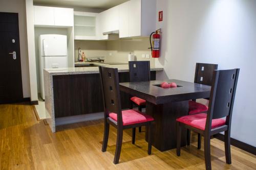 a kitchen with a table and chairs in a room at Executive Suite - QUITO in Quito