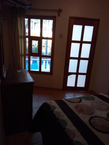 a room with two windows and a rug on the floor at Hotel Plaza del Sol in Malinalco