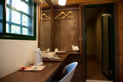 a bathroom with a wooden desk with a computer on it at Maylin B&B in Xinshe