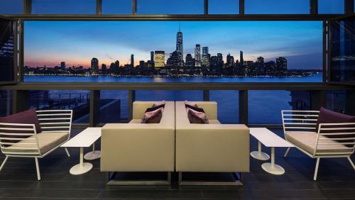 a balcony with a view of a city skyline at Hyatt House Jersey City in Jersey City