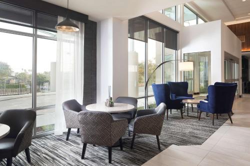 a lobby with chairs and tables and windows at Hyatt Place Santa Cruz in Santa Cruz