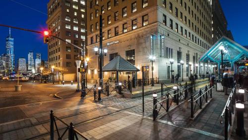 a city street at night with a red traffic light at Hyatt House Jersey City in Jersey City