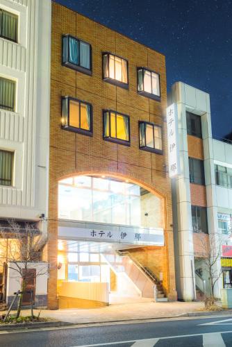 a brick building with an archway in front of it at Hotel Ina in Ina