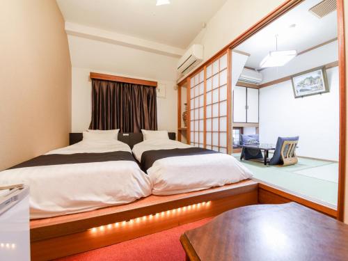 Postel nebo postele na pokoji v ubytování Tanegashima Araki Hotel