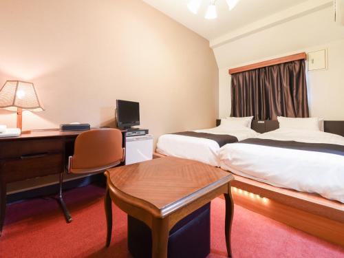 Postel nebo postele na pokoji v ubytování Tanegashima Araki Hotel