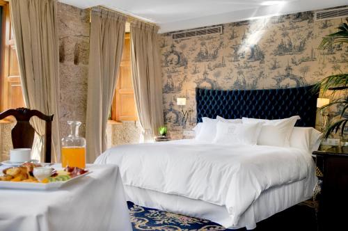 Cama o camas de una habitación en A Quinta Da Auga Hotel Spa Relais & Chateaux