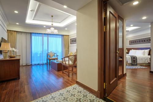 a hotel room with a bedroom and a bed at Silk Path Grand Sapa Resort & Spa in Sa Pa