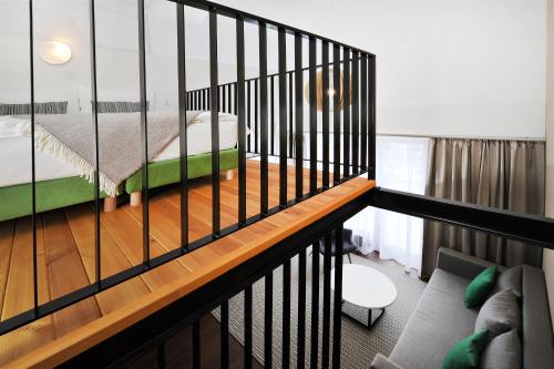 a view of a bedroom with a bed and a couch at APLEND Vila Olívia in Smokovce