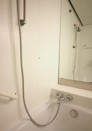 a shower in a bathroom with a sink and a mirror at Appartamenti Boboli in Punta Ala