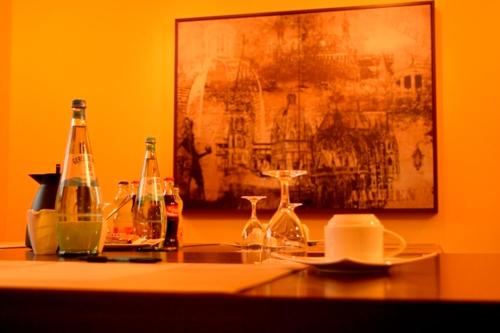 a table with bottles and glasses on top of it at Vichter Landhaus in Stolberg