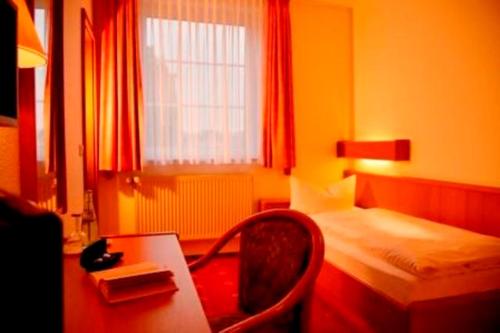 a bedroom with a desk and a bed and a chair at Vichter Landhaus in Stolberg