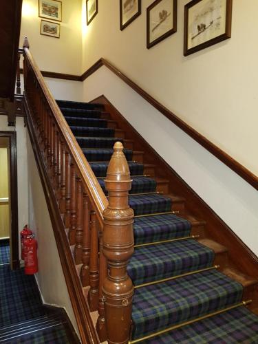a set of stairs in a house with blue carpet at Ardshiel Hotel in Campbeltown
